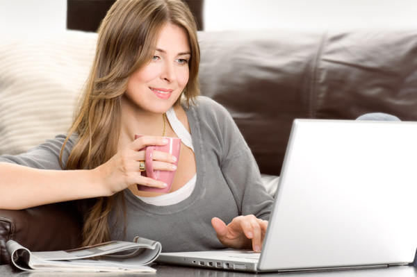 Women reading news on laptop